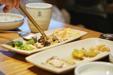 Person using chopsticks to eat food