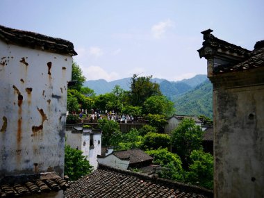 Mavi gökyüzünün altındaki dağların ve binaların manzarası
