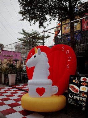 Şişirilebilir tek boynuzlu at heykeli kalp dekorasyonu yakınlarında.