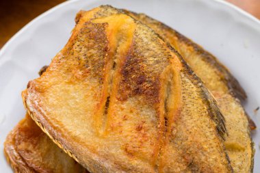 Tayland usulü kızarmış yılan derisi gourami tabakta servis edilir, çıtır çıtır altın-kahverengi deri ve iştah açıcı doku gösterilir..