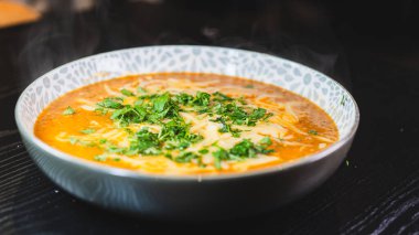 Erimiş peynir ve taze soğanla kaplı kalın, nefis sığır güveci. Zengin, rahatlatıcı ve lezzet dolu. Soğuk günler ve ev yapımı yemekler için mükemmel..