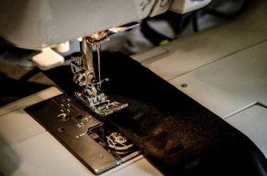 İğneye iliştirilmiş iplik içeren ayak dikiş makinesi