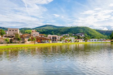 Capitolio - MG, Brazil - December 08, 2020: Houses next to the Furnas lake at the shore and the hills on background. Urban area of Capitolio city.