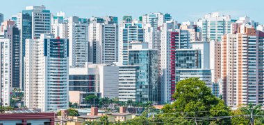 Cityscape of Gleba Palhano neighborhood at Londrina city, PR, Brazil. High density area of commercial and residential buildings. Brazilian city known as Little London, in honor to London city. clipart