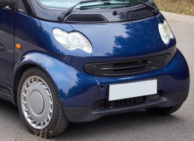 Little blue car driving on the road,  modern city car background