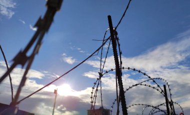 Dikenli tel örgülü metal çitler yakın fotoğraf, hapishane ve özgürlük sınır çizgisi kavramsal arka plan