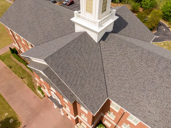 Wake Forest, NC 'de büyük bir mimari çatı sisteminin havadan görüntüsü. Özellikler arasında merkezi beyaz bir kubbe, hassas kaplamalı birden fazla kesişen çıkıntılar ve temiz tuğla entegrasyonu yer alıyor..