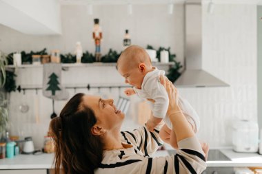 Anne mutlu bir şekilde bebeğiyle oynuyor. Kaliteli fotoğraf. Anne mutlu bir şekilde bebeğiyle oynuyor.