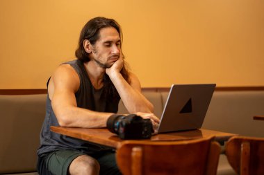 Adam dizüstü bilgisayar kullanırken kafasının dinlenmesinden sıkılmış.