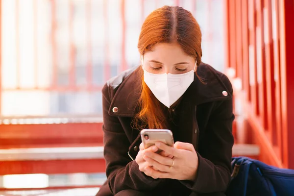 Beautiful woman in medical mask with phone, coronavirus or virus Covid-19 concept