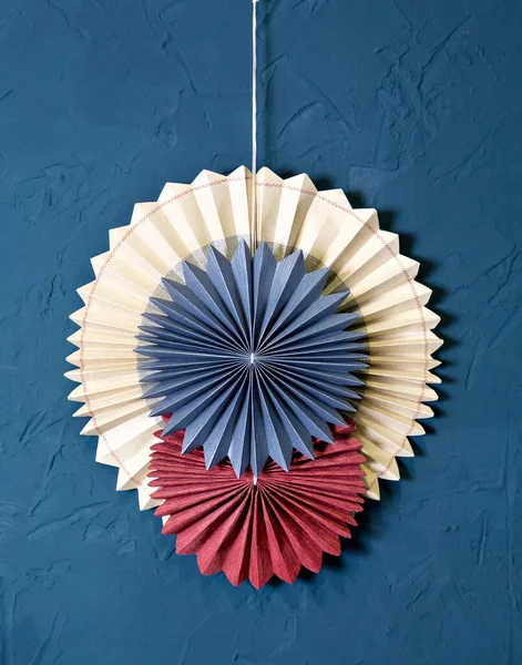 Round paper harmonica Interior decoration: paper circles on the blue wall