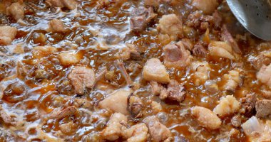 Cooking process of traditional Uzbek plov with meat, fat, and spices. High quality photo