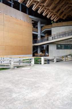 HANGZHOU, ÇİN - 08 Temmuz 2017: Çin Sanat Akademisi 'ndeki bir avlunun iç görünümü. Boşlukta, sol tarafta uzun sarı bir toprak duvar ve üzerinde geleneksel malzemelerle modern uzayı harmanlayan karmaşık bir ahşap çatı yapısı bulunuyor..