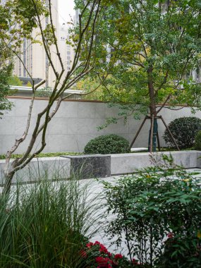 Dokulu taş, yeşil yapraklar ve doğal otların altını çizen huzurlu bir bahçe manzarası. Görüntü organik güzellik, denge, farkındalık ve sakin bir atmosfer taşır. Sığ alan derinliğine sahip yüksek kaliteli gerçek fotoğrafçılık.