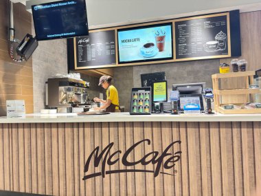 Jakarta, Endonezya - 15 Ocak 2026 - Jakarta 'da bir McDonald' s ve McCaf restoranının dış tarafında müşteriler akşam lambaları altında yemek yiyor..