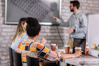 Modern iş adamlarından oluşan bir grup, yaratıcı ofiste mimari tasarımları tartışıyor..