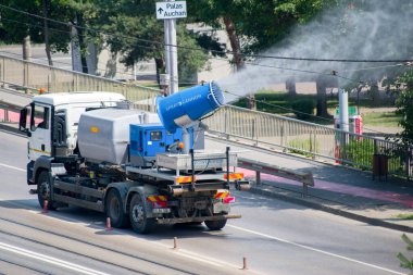Şehir caddesi, Iasi, Romanya 'da kirlilik önleyici su püskürtme kamyonu. Sis tabancası ya da toz önleyici kamyonlar, PM2.5 ve PM10 gibi havadaki partikül maddeleri azaltmak için ultra ince bir su püskürterek çalışır..