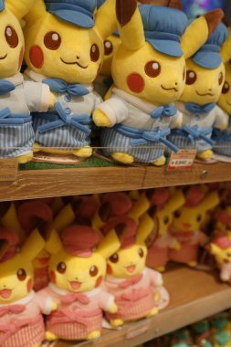 Vertical shot of a close-up view of shelves of Pikachu plushies at the Tokyo Pokemon Cafe gift shop in Nihonbashi, Tokyo, Japan