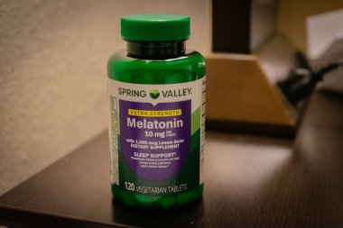 Bir şişe Spring Valley markalı melatonin tabletleri ABD 'nin Tennessee şehrinde bulunan Pigeon Forge' da bir komodinin üzerinde.
