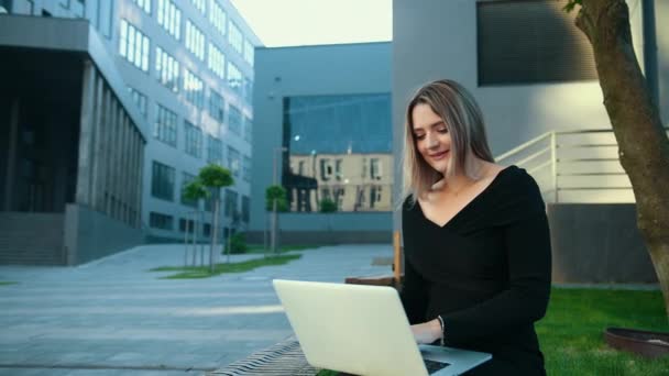 Usando tecnología al aire libre. Mujer joven trabajando. Mujer de negocios con portátil — Vídeos de Stock