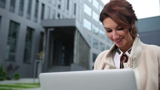 Vacker affärskvinna med laptop sitter på trappor utomhus. Damdator. — Stockvideo