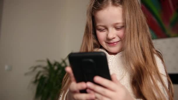 Chica joven viendo un video en su teléfono móvil que está viendo videos divertidos — Vídeos de Stock