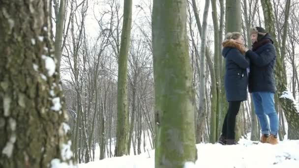 Beautiful couple of young adults having fun on vacation snow-covered winter — Stock Video