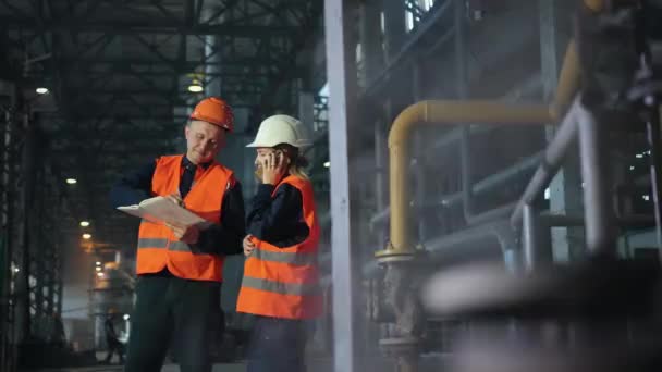 Dos ingenieros de mantenimiento hombre, mujer inspeccionar. Trabajo industria pesada fabricación — Vídeo de stock