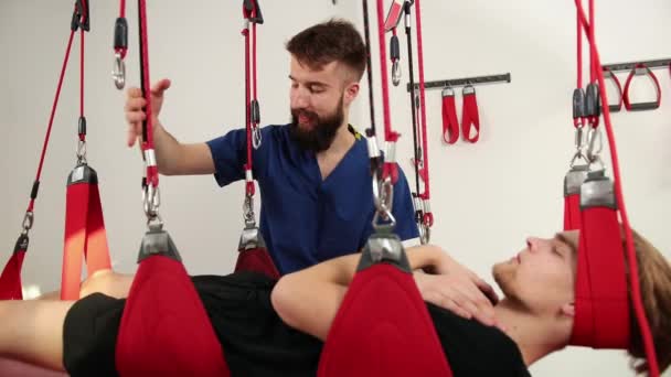 Physiotherapist doing a back treatment to the patient in physiotherapy room. — Stock Video