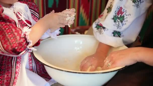 Prodotti da forno fatti a mano. Madre e figlioletta impastano la pasta per cuocere il pane — Video Stock