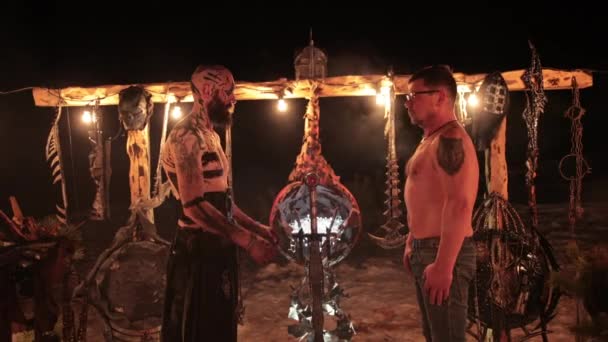 Evil aggressive viking warrior in northern tattoos bare torso with a european — Stock Video