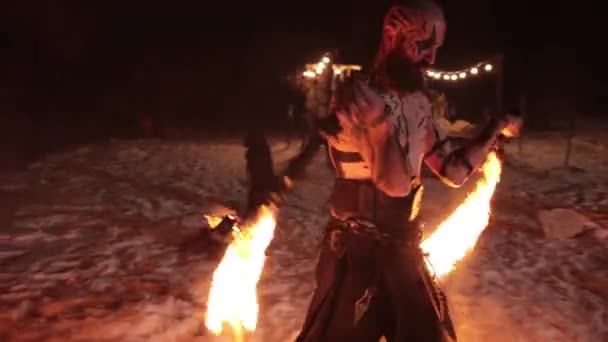 An evil aggressive viking warrior in northern tattoos with a bare torso burning — Stockvideo