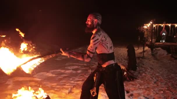 Evil aggressive viking warrior in northern tattoos bare torso sets fire swords — Stock Video