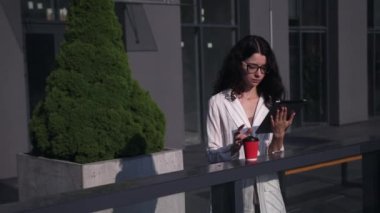 Yaz parkında kahve fincanı okuyan bayan. Gözlüklü çekici bir genç kadın.