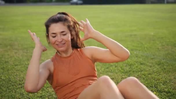 Exercise fitness woman training abs sit up on grass. Girl doing bicycle crunch — Stock Video