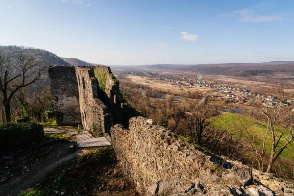 Antik taş tahkimatı bir tepenin üzerinde duruyor, aşağıdaki küçük bir kasabayla Ukrayna kırsalının panoramik manzarasını sunuyor.