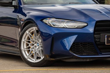 Mavi BMW M3 yarışması ön çeyrek kapanış, lüks spor sedan far ve tekerlek ayrıntıları açık havada