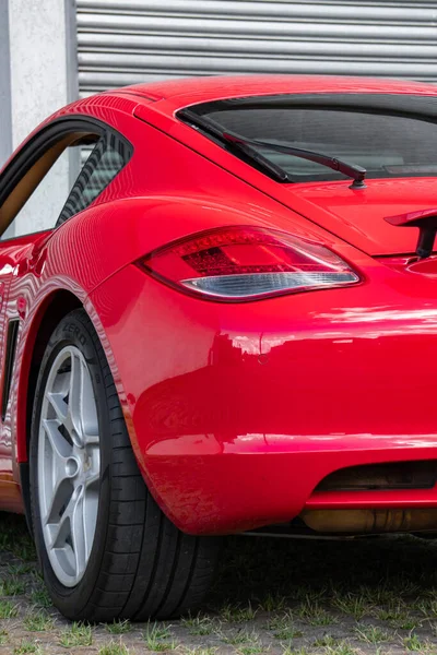 Kırmızı Porsche Cayman 'ın arka tarafı yakın çekim, lüks spor araba arka lambası ve kanat detayları
