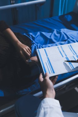Man with abdominal pain, bloating, diarrhea goes to the doctor at medical clinic. Female doctor is diagnosing a patient abdominal pain in the examination room at the hospital.