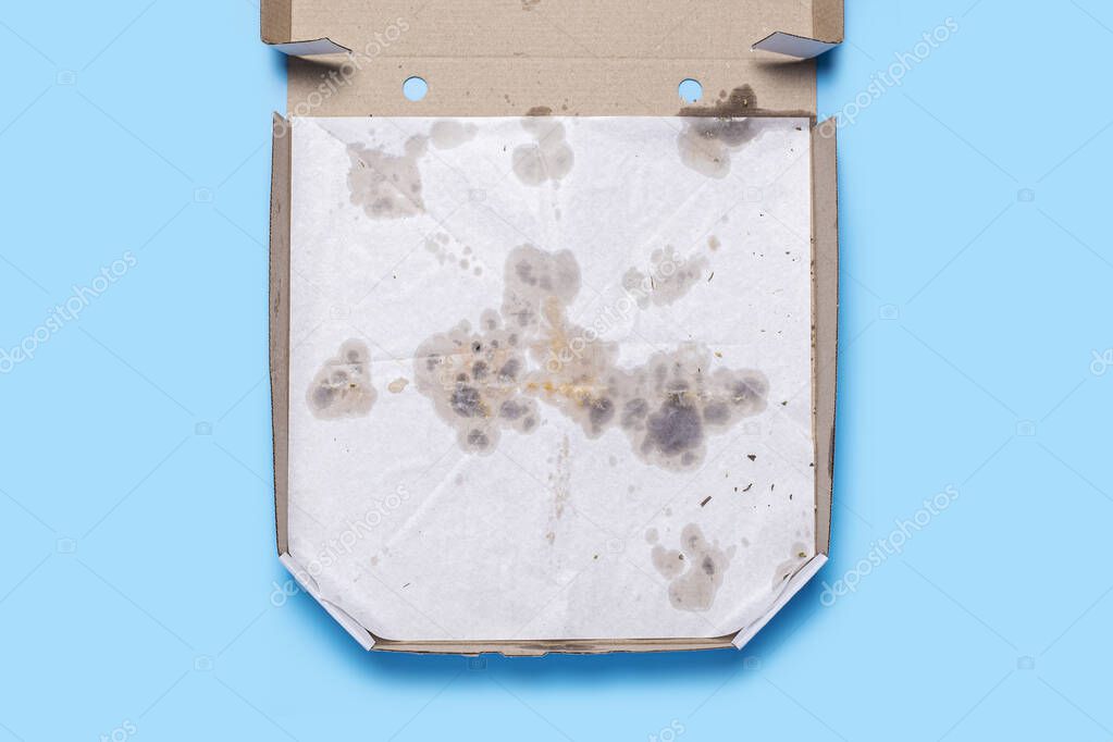 empty open pizza packaging on blue background. Top view, flat lay.