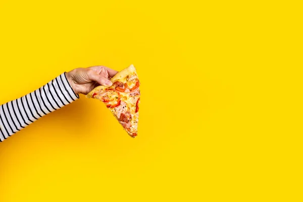 Samica Trzyma Kawałek Świeżej Gorącej Pizzy Żółtym Tle — Zdjęcie stockowe