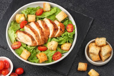 Kızarmış tavuk göğsü ve salata taze ıspanak, kızarmış ekmek, kiraz domatesleri, tavuk, kızarmış ekmek, marul ve kızarmış ekmek.