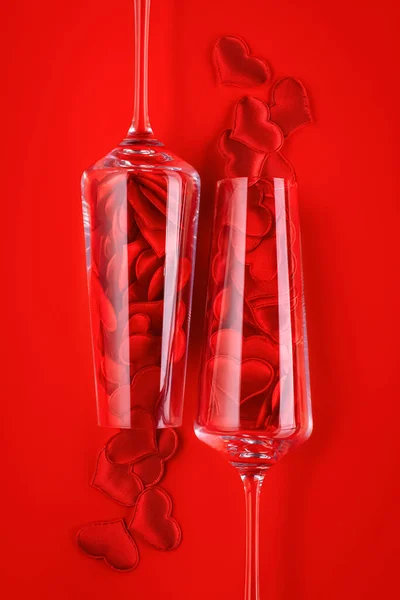 Два Келихи Шампанського Яких Червоні Серця Виливаються Яскраво Червоне Тло — стокове фото
