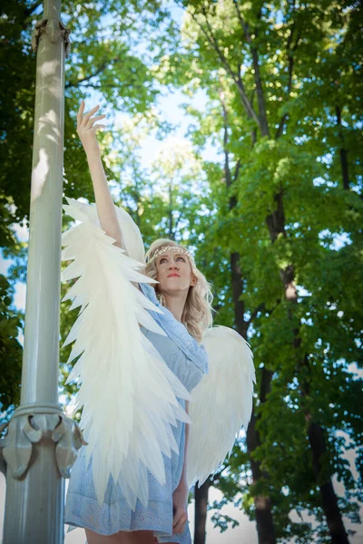Angel girl with large white feather wings