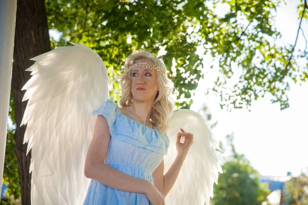 Angel girl with large white feather wings