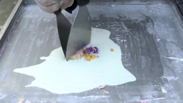 Wykonanie naturalnych owoców tajskie lody. Produkcja lodów w rolkach na zimnym talerzu. Kucharze robią roladki lodów na patelni, ręcznie robiony deser lodowy. — Wideo stockowe