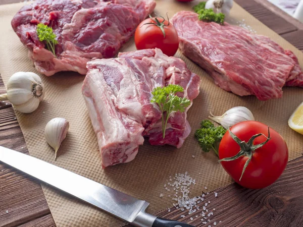 Vários Pedaços Carne Crua Fresca Estão Espalhados Pergaminho Lado Alho — Fotografia de Stock