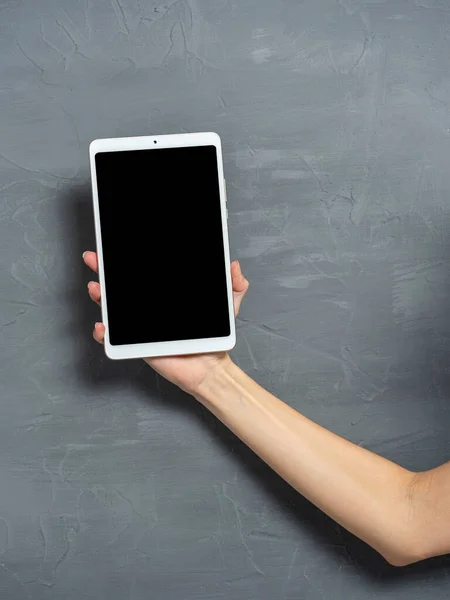 Woman Hand Holds White Tablet Gray Textured Background Place Insert — Stock Photo, Image