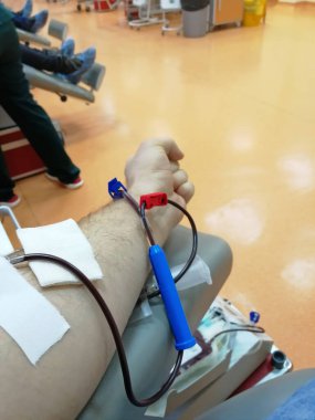 Bir adamın eli, içinden bir tüp kan gelir. Bağış kavramı, insanlara yardım etmek.