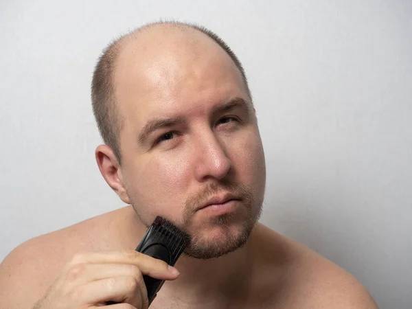 Homem Fundo Cinzento Rapa Barba Com Uma Navalha Eléctrica Ele — Fotografia de Stock